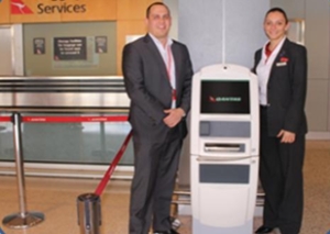 Quantas employees with the BagAssist kiosk 